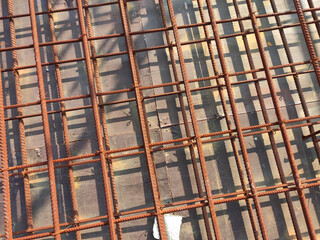 SEREMBAN, MALAYSIA -MARCH 29, 2020: Construction workers fabricating steel reinforcement bar at the construction site. They tied it together using the tiny wires before cover it up using formworks. 