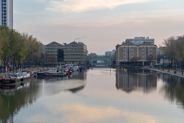 Fototapeta premium Paris, France - 11 07 2020: Reflections on the Ourcq canal of the lift bridge at sunrise