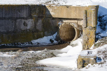 Draining drainage water through a sewer pipe. Melting snow in spring.