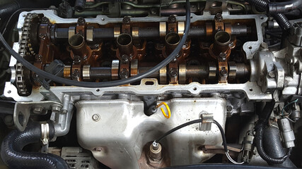 Close-up on a disassembled engine with a view of the gas distribution mechanism, chain, gears and...