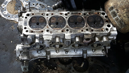 Close-up on a disassembled engine with a view of the gas distribution mechanism, chain, gears and tensioners during repair and restoration after a breakdown. Auto service industry.