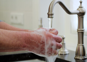 person washing hands with soap and water, hygiene 