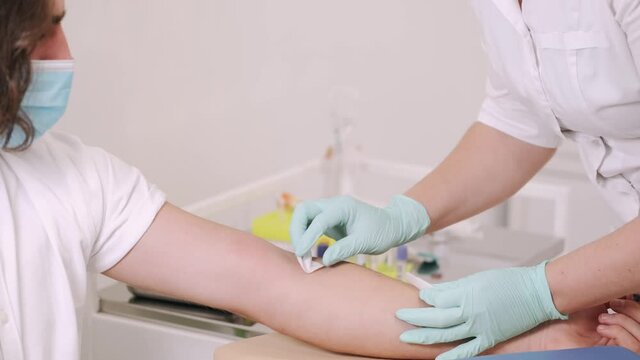 doing blood test sample  for safety doctor woman patient hand medical nurse medicine care health hospital people injection treatment massage bandage clinic body child pain therapy beautiful white heal
