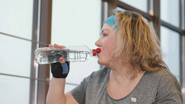 woman dirking water woman water young people kitchen drink indoors glass boiler beauty person gas holding heater happy care broken health portrait drinking bottle healthy child apparatus washing