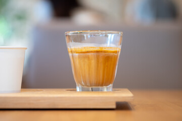Dirty coffee. A glass of espresso shot mixed with cold fresh milk in coffee shop