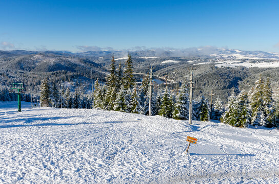 Beautiful panoramic view over the "Marisel" ski slope in winter season and Belis lake in the valley, Cluj county Romania.