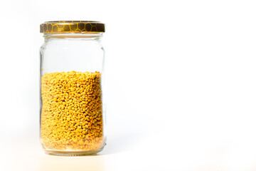 Glass jar with Italian bee pollen on white background