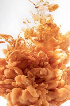 A Vertical Shot Of Vibrant Orange Ink In The Water