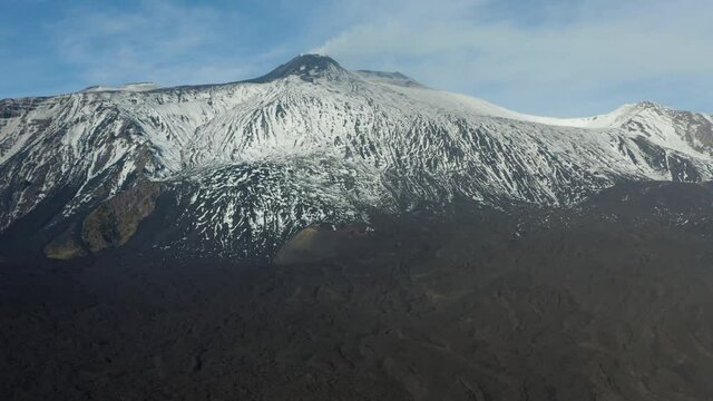 Etna with a view of the South East crater after a snowfall and the spectacular Valle del Bove with its dikes and solidified lava flows. Sicily. Italy.