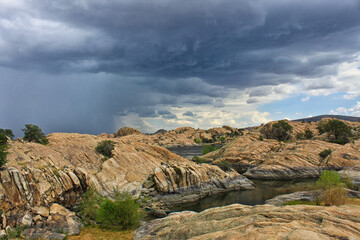 Incoming rain with clouds and rocky landscape  - 401803549