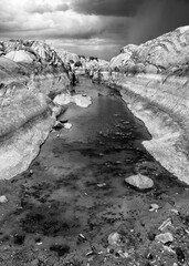 Black and white stream with rock formations - 401803742