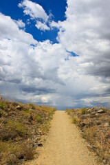 The road to the clouds, dirt road landscape. - 401804128