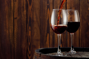 pouring red wine in glass