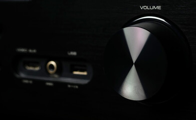 Front side of the AV receiver with volume knob close-up.	

