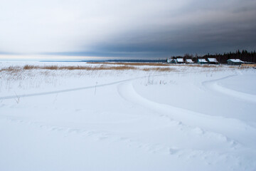 Village at the covered with snow seaside