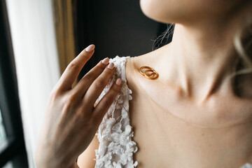 Wedding rings at the bride's collarbone