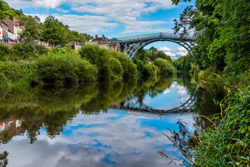 The view down the River Severn of the town of Ironbridge, Shropshire, UK and the bridge that gave...
