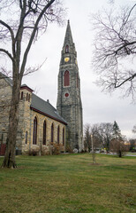 Fototapeta na wymiar Goshen, NY - USA - Dec. 26, 2020: a vertical view of the historic First Presbyterian Church in Goshen. The church was built in 1871 and is the tallest structure in Orange County, NY.