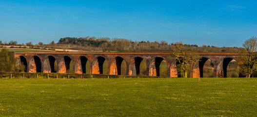 Sunshine on a winter day bathes the Victorian railway viaduct for the London and North
