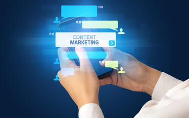 Female hand typing on smartphone with CONTENT MARKETING inscription, social networking concept