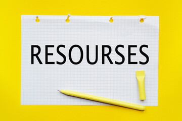 RESOURCES inscription on white list, yellow pen on a yellow background. a bright solution for business, financial, marketing concept