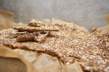 Dried flax seed crackers on the sheet of paper.  