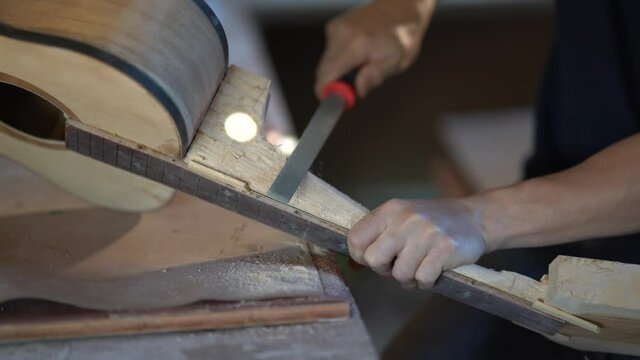 craft man making guitar on wood table, capenter working concept