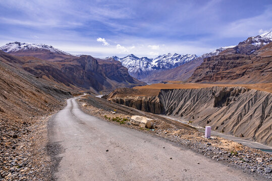 View from hilly mountain road  travelling to Chandrataal Lake through gully eroded geological landform prominent in cold desert of Spiti valley due to barren steep slopes and weak geological mud rocks
