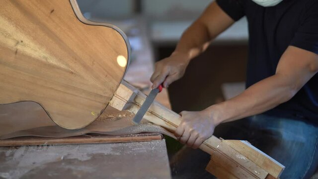 craft man making guitar on wood table, capenter working concept