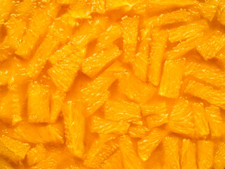 Flatlay. Top view of orange jelly dessert. Pieces of juicy oranges in a transparent fragrant edible gel. Minimalism in food. Bright food background. Copy space.