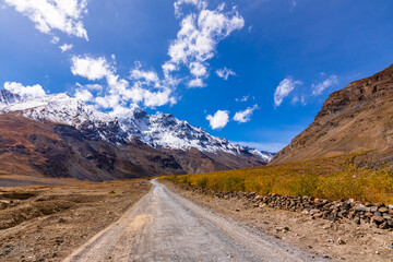 Cold desert barren landscape of Spiti mountain valley with sparse grass vegetation of bunchgrass,...