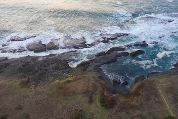 The cold waters of the Pacific Ocean wash against the rocky Northern California coastline in Mendocino. The scenic Pacific Coast Highway runs along this amazing part of the west coast.