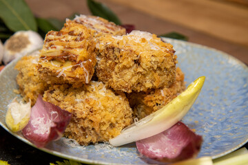 A delicious plate of deep fried Lasagna squares on a plate