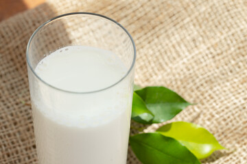 Glass cup of milk on table close up