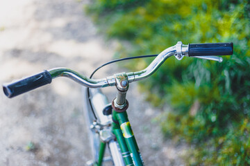 Obraz na płótnie Canvas Retro bicycle handlebar and breaks outdoors, blurred background