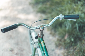 Retro bicycle handlebar and breaks outdoors, blurred background