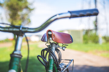 Retro bicycle seat outdoors, summer day, blurred background