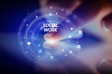 Finger touching tablet with social media icons and SOCIAL WORK