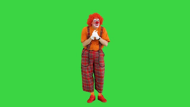 Funny clown having some hard thinking and coming up with some decision on a Green Screen, Chroma Key.