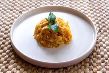 Potato and carrot puree on white plate with wicker background. Vegetable purees on a white plate. One meal with healthy veggies.