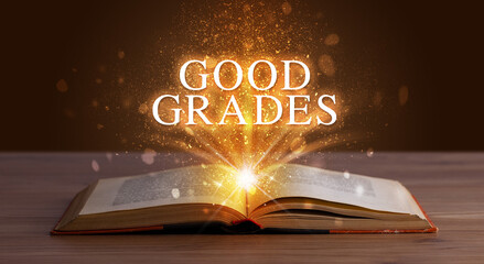 GOOD GRADES inscription coming out from an open book, educational concept