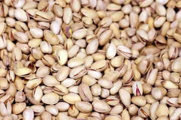Pistachio nuts, selective focus. Roasted and salted pistachios in shells on the market