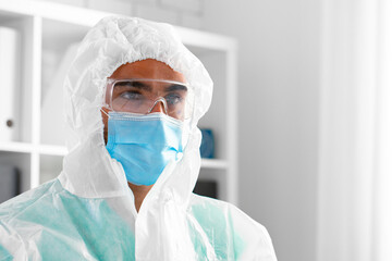 Male doctor in protective medical uniform in clinic