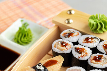 Set of maki sushi on wooden boat tray