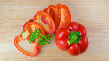 Bulgarian red ripe pepper on a wooden background