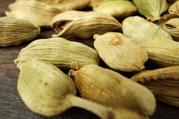 Сardamom spice bunch on wooden table macro