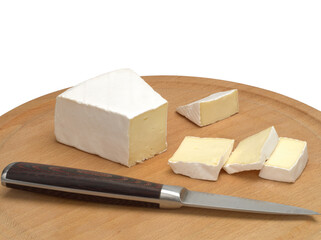 Brie cheese with cut slice on a wooden board isolated on a white background