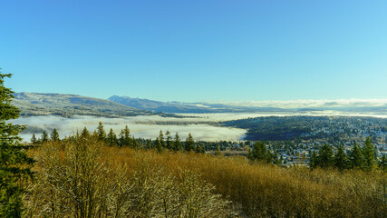 Cloud inversion in valley with alpine mountain backdrop
