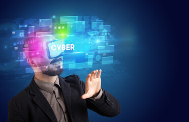 Businessman looking through Virtual Reality glasses with CYBER inscription, innovative security concept