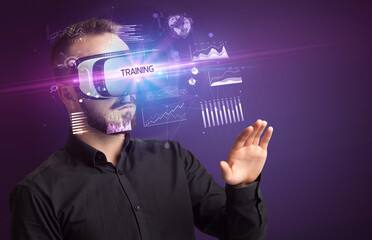 Businessman looking through Virtual Reality glasses with TRAINING inscription, new business concept